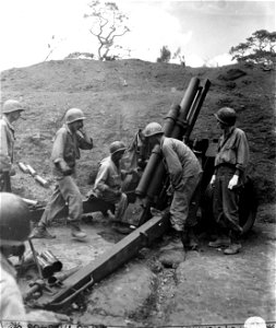 SC 364528 - B Battery, 126th, 2 Gun Section throws some steel at the Japs. This 105mm howitzer is the registration gun for the Regiment as both the gun and crew are the most reliable.