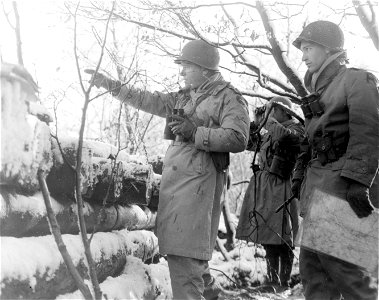 SC 329699 - Maj. Gen. Joseph Collins, left, Commanding General, VII Corps, points out a German withdrawal movement, at a forward observation post near Duren, Germany. 10 December, 1944. photo