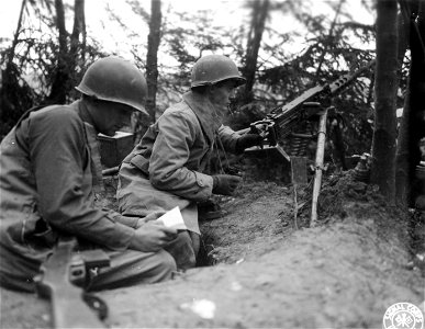 SC 396906 - Seventh Army cavalrymen (L-R) Pvt. Ralph W. Adams, 11 Boutelle St., Leominster, Mass., and Pvt. Frank G. Lapka, 115 Honesdale Rd., Carbondale, Pa., wait by their machine gun for further enemy activities... photo