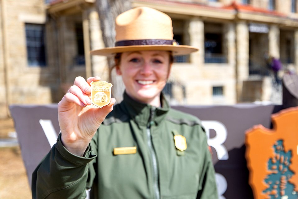 Ranger showing off Yellowstone's new junior ranger badge