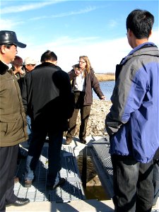 Biologist Wendy Woyczik demonstrates a type of water control structure photo