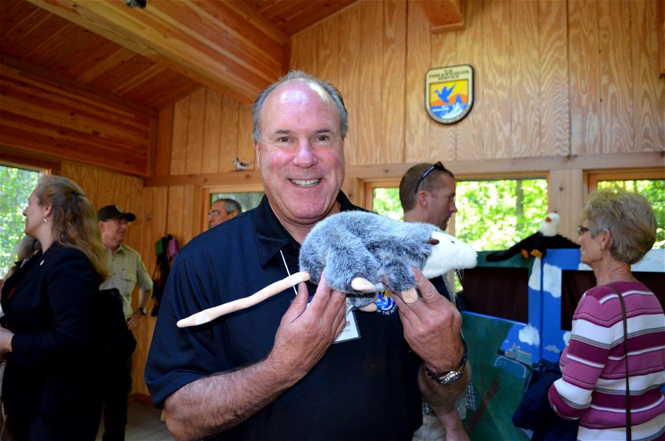 Deputy RD Charlie Wooley plays "possum." The new facility includes educational puppets and hands-on toys for kids of all ages to learn about wildlife.