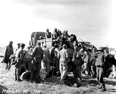 SC 171624 - Unloading German prisoners arriving at one of the P.O.W. camps in Mateur, Tunisia, North Africa. 10 May, 1943. photo
