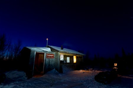 A snowmachine and sled outside the Paniqsigvik shelter cabin. photo