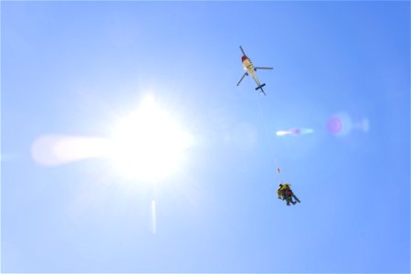 Yellowstone Helitack short-haul training: crew hauling patient to safety photo