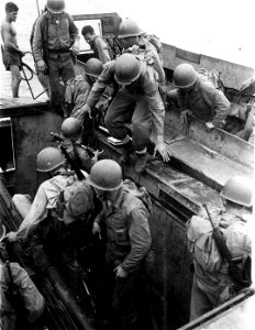 Transferring from Higgins Boats to amphibious tractors. Guadalcanal. 10 March, 1944.