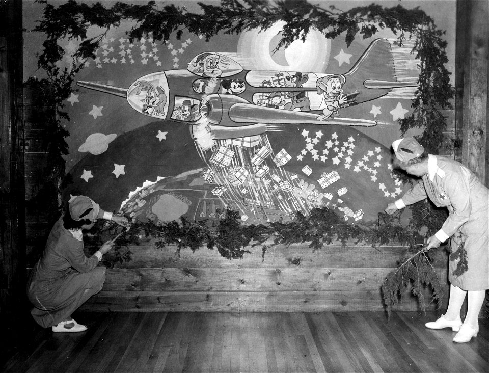 SC 374653 - Two ladies in grey at the Red Cross auditorium in the Regional Hospital at Camp Swift are seen putting the finishing touches to a mural painted on one of the walls in the auditorium.