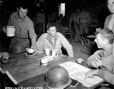 SC 171633 - Capt. Edwin W. Eldar, Infantry, taking refreshments after Americans had freed him and others from an Italian prison ship in the Tunis Harbor. 9 March, 1943. photo