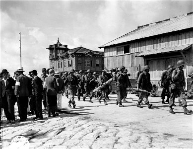 SC 270789 - Troops of the 17th Inf., 7th Div., marching toward Jensin after landing. First troops in Korea. 8 September, 1945. photo