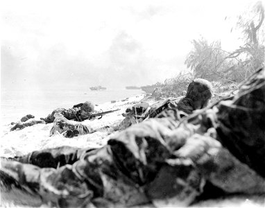 Marines hug beach on first day. Saipan. 15 June, 1944.