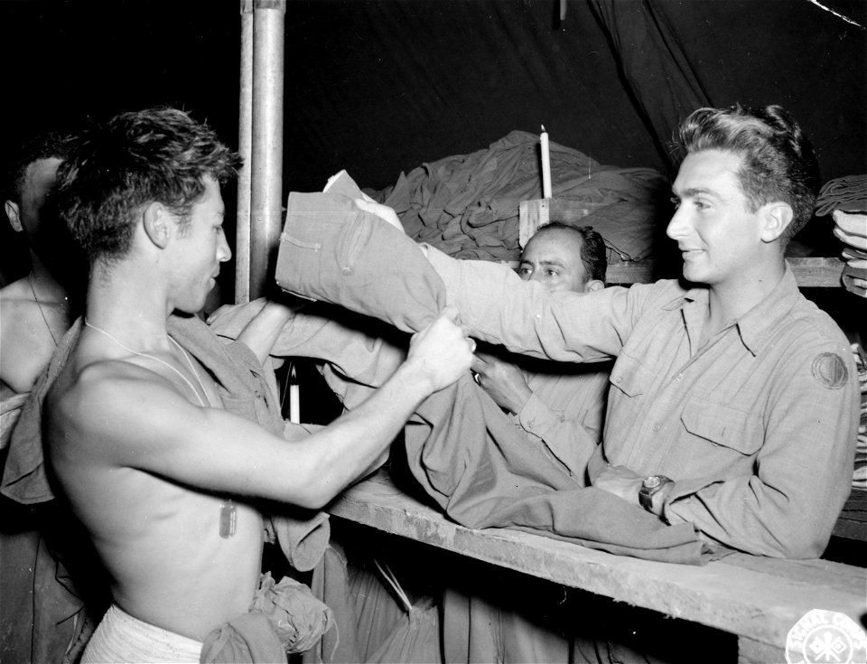 SC 196122 - Pvt. Genaro G. Gomez, 337th Regt., 85th Div., the first man to use the new 85th Div. showers set up close behind the front lines...