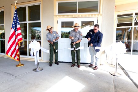 Mammoth Hot Springs Hotel reopening ceremony: Peter Galindo, Cam Sholly, and Mike Keller cut the ribbon