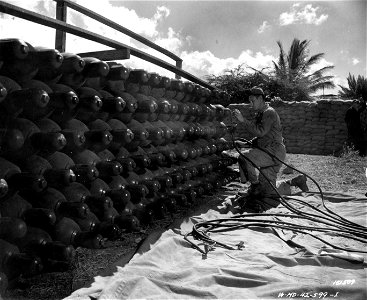 SC 151509 - T/5 Addison starts connecting up the hoses that supply the balloon with hydrogen gas. Fort Kam, Hawaii.