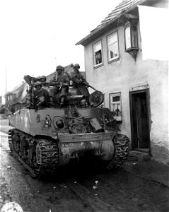 SC 364386 - Colored infantry load up on lead tank to go into wooded area where a number of Germans have been reported. photo