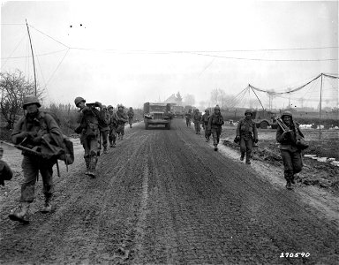 SC 270590 - Members of Co. G, 2nd Battalion, 9th Infantry Regiment, 2nd Division, U.S. First Army, march back from the front for regrouping at Elsenborn, Belgium. 20 December, 1944. photo
