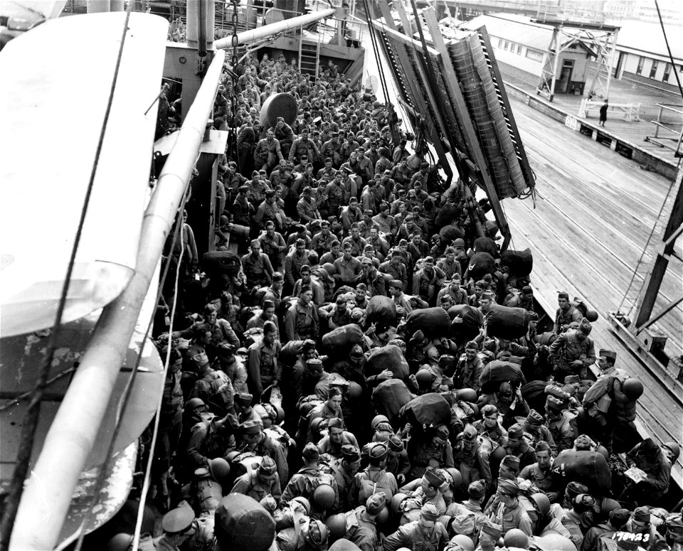 SC 170423 - Part of the troops carried on a Dutch liner converted into a U.S. Army transport, prepare to debark, somewhere in Australia. photo