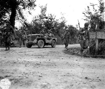 SC 270660 - Infantrymen move toward the front beyond St. Lo, France, after the Air Corps and artillery paved the way with their "Greatest show since D-Day". 26 July, 1944. photo