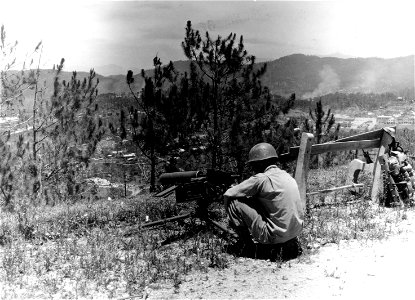 SC 364518 - Pfc. Adolph Fox, Co. D., 130th Inf., from Detroit, Mich., firing at sniper positions from top of Monastery Hill, overlooking Baguio city, Luzon, P.I. photo