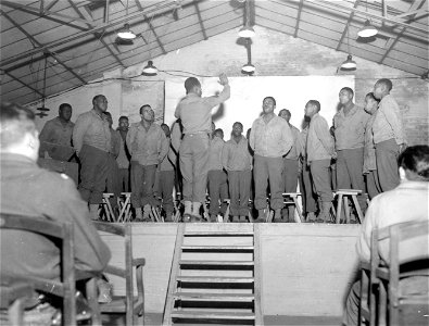SC 364371 - GI chorus entertains U.S. troops at large HQ in Belgium on Christmas Eve. photo