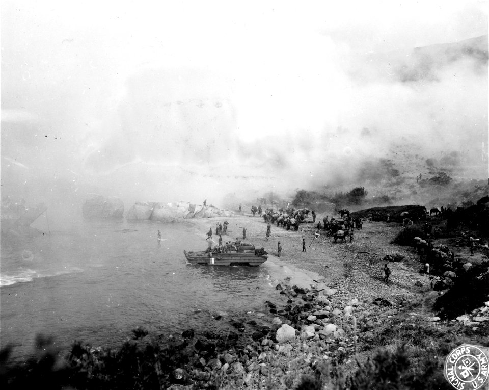 SC 329861 - Invading troops of the 5th Colonial Inf. Div. coming ashore at Marina Di Campo, Elba, under protection of smoke screen. 17 June, 1944.