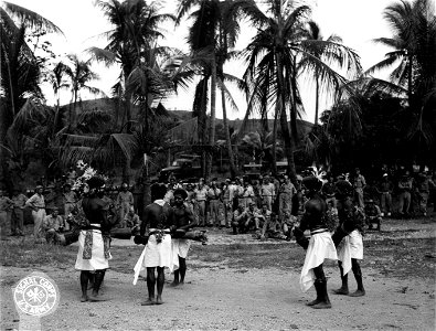 SC 364415 - Papuan natives furnish Christmas entertainment for Yanks and Aussies by performing one of their native dances at Fort Moresby, New Guinea. 25 December, 1943. photo