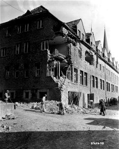 SC 335279 - Patients of this hospital and civilians help to clean up the rubble made by shelling and bombing the Germans did trying to stop the advance of the 99th Infantry Division, U.S. First Army, through Hausen, Germany. photo