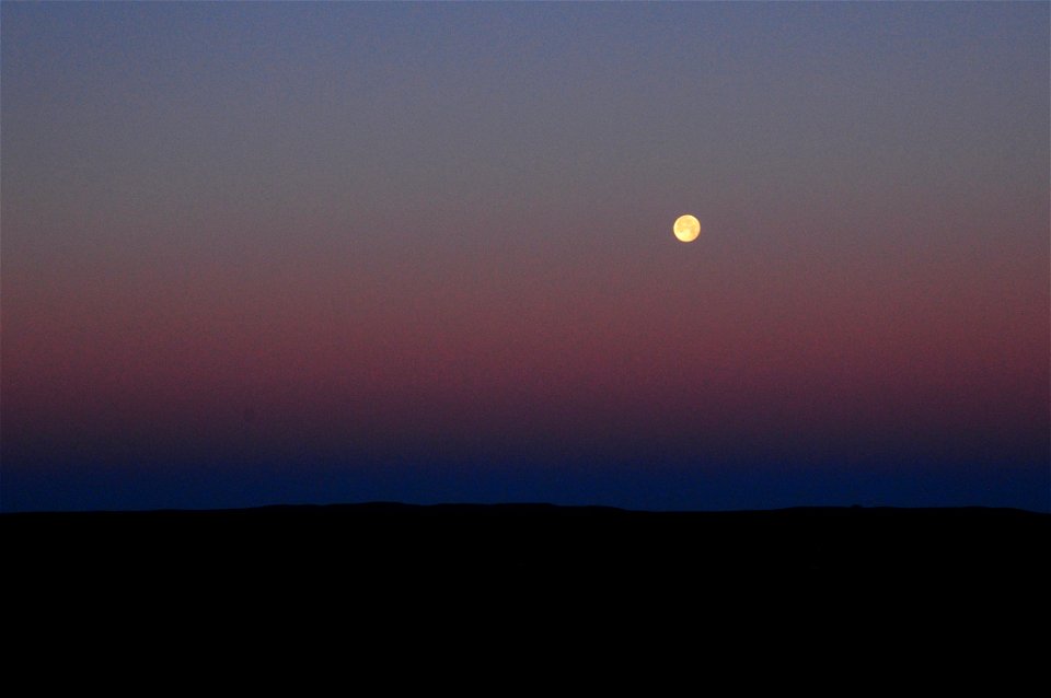 Strawberry moon setting over sage steppe at Seeskadee National Widlife Refuge Wyoming