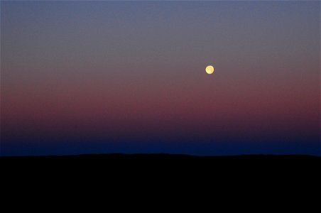 Strawberry moon setting over sage steppe at Seeskadee National Widlife Refuge Wyoming