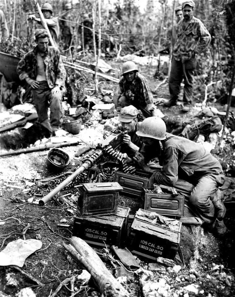 SC 364499 - Pvt. Andy Hamilton, Vincentown, New Jersey; Pvt. Chester Klovas, Chicago, Ill.; Pfc. Harry Reynolds, Loogoote, Ind.; gun crew of the .50 caliber machine gun is credited with half of 109 Japanese slain on Biak Island on the 22 June 1944.