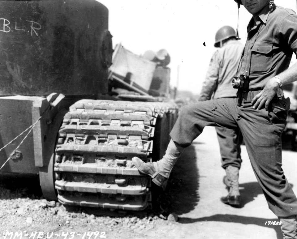 SC 171655 - The track of a German Mark VI tank in comparison to a man's foot. Beja, Tunisia. 23 April, 1943.