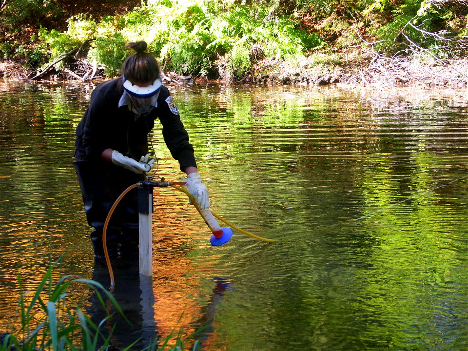 Biological Science Technician Cassie Abrams from the Marquette Biological Station ensures an accurate lampricide application rate during a treatment of the Manistique River photo