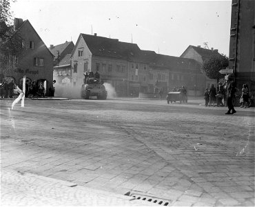 SC 335314 - Tanks of 9th Armored Division and infantrymen of 69th Division, 1st U.S. Army, roll into newly-taken Kölleda, Germany. 12 April, 1945. photo