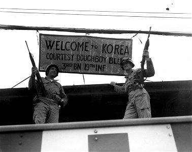 SC 348885 - L-R: M/Sgt. Albert R. Charleton, Salem, Ill., and 1st Lt. Harry J. Lumani, Cumberland, Md., both of the 19th Inf. Regt., 24th Div., put up welcome sign for the newly-arrived Philippines combat troops at Pusan, Korea. photo