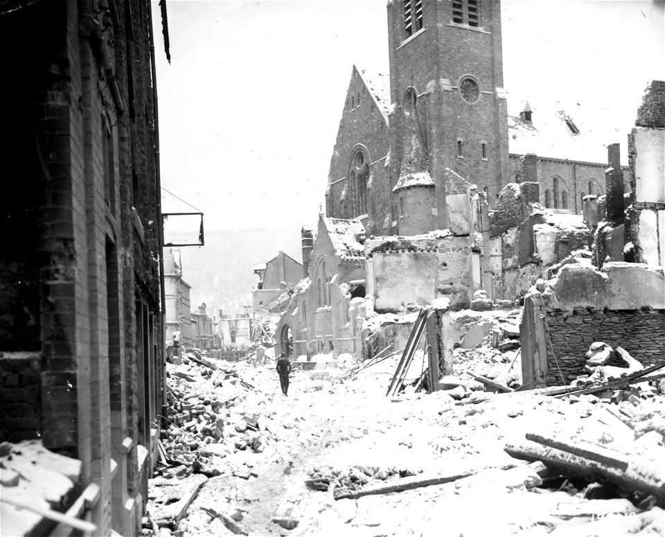 SC 199108 - A civilian casually picks his way through the rubble - all that remains of the Belgian town of La Roche, entered earlier in the day by Allied troops. 12 January, 1945.