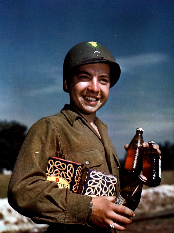 C-2363 - Pfc. James C. Brown of Tulsa, Okla., enjoys his first American beer and pretzels at Camp Oklahoma City, one of the camps set up for redeploying the American Army to the U.S. and the South Pacific.