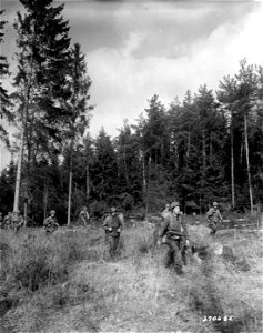 SC 270685 - Infantrymen of the 11th Regt., 5th Div., U.S. Third Army, march across rough ground enroute to Winterbach, Germany, to clear out German soldiers cut off from their main troops in retreat. 18 March, 1945. photo