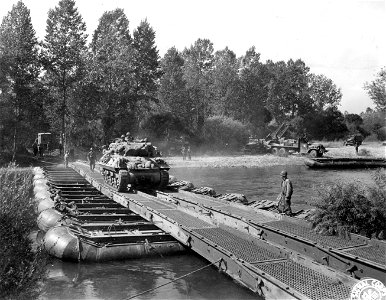 SC 195548 - A tank destroyer crosses the Moselle River at Neuville-Sur-Moselle, France, over a treadway bridge built by U.S. Army engineers.