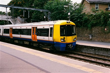 London Underground train 378 206 in old livery enters Highbury & Islington station platform 8, bound for Stratford. photo