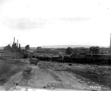 SC 335273 - Vehicles of the 10th Armored Division, U.S. Third Army, enter the shell-torn town of Kaiserslautern, Germany, during their drive toward the Rhine River. 20 March, 1945. photo