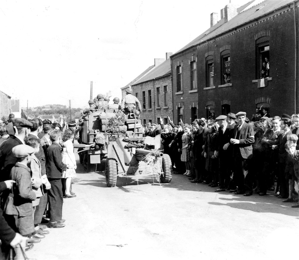 SC 3299941 - Residents of Couvin, Belgium, flock into the streets of their town to cheer the vanguard of American troops rolling eastward across their country into Germany. 3 September, 1944.