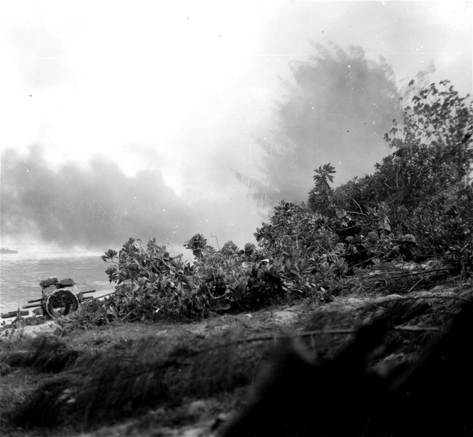 Marines crouched along Green Beach 2, D-Day. Saipan. 15 June, 1944.