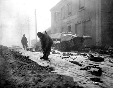 SC 337213 - Signalmen of the 17th Airborne Division are laying wire through the town of Marnach, Luxembourg, to an artillery observation post. photo