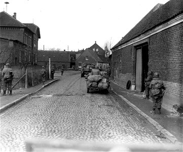 SC 336784 - Infantry of the 35th Division, 9th U.S. Army move through the town of Severen, Germany, clearing German snipers out as they move forward. 3 March, 1945.