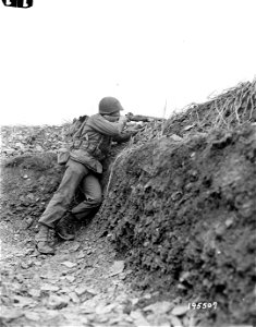 SC 195507 - Sgt. Justus K. Westover, Rapid City, S.D., takes aim from an observation point in a 1918-style trench on the German border (Krinkelt) near Belgium. photo