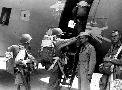 SC 329696 - Major John Britten, CO of 2nd Bn., 503rd Parachute Inf. Regt., checking some of his men into plane prior to practice jump at Port Moresby, New Guinea. 17 November, 1943. photo