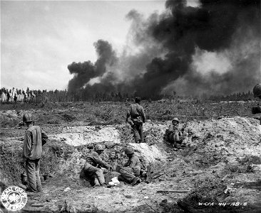 SC 270782 - Jap fuel dumps burn on Kwajalein Island after being hit by artillery shells from Enubuj Island.