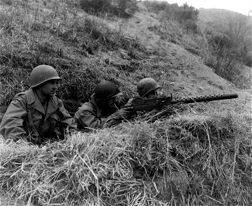 SC 364040 - Men of the French Bn. scan the hillside for enemy troops from their machine gun emplacement near Oum Ni(?), Korea. photo