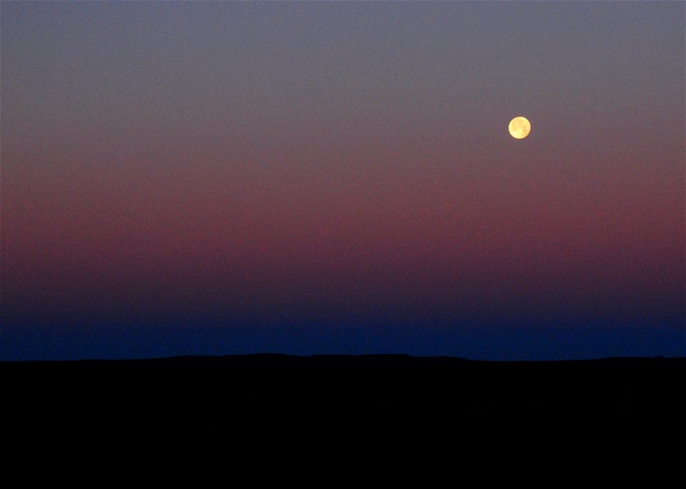 Strawberry moon setting over sage steppe at Seeskadee National Widlife Refuge Wyoming