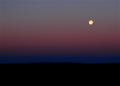 Strawberry moon setting over sage steppe at Seeskadee National Widlife Refuge Wyoming