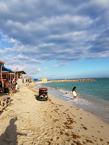 Beach and Shacks by the ocean under the skies in Kingston, Jamaica photo